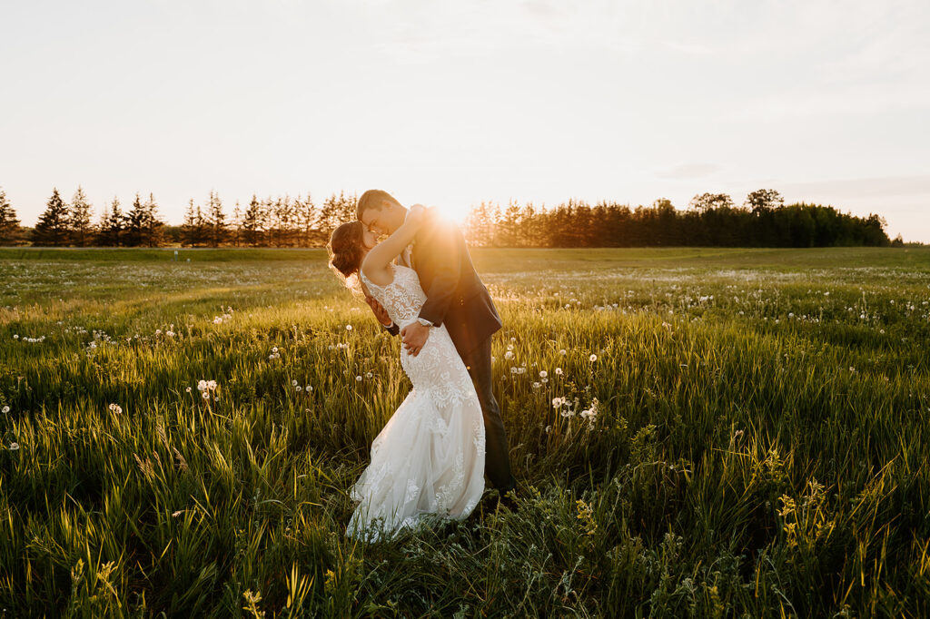 bride and groom golden hour wedding photos in a field