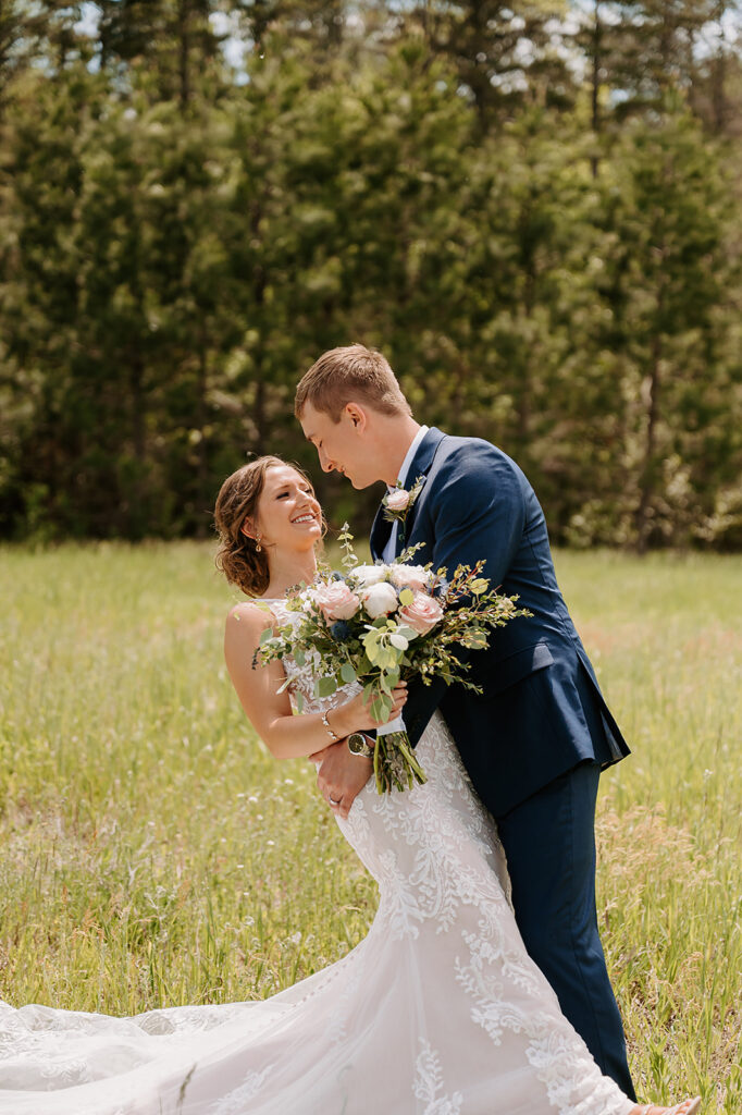 romantic bride and groom wedding photos in a lush field in Minnesota