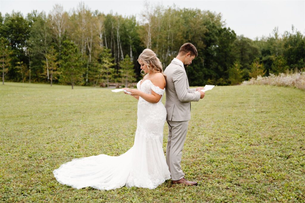 bride and groom first touch in a beautiful field, Bemidji MN