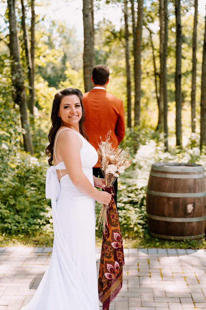 bride and groom wedding first look in forest in Minnesota