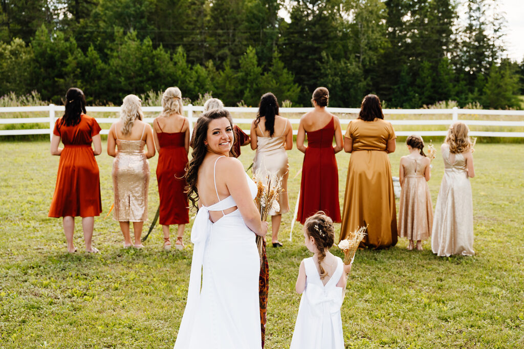 bride and bridesmaids first look, bridesmaids wearing terracotta mismatched bridesmaid dresses