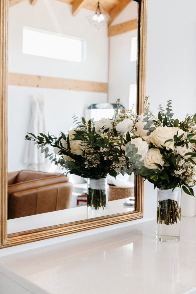 Bridal bouquet in vase by the mirror