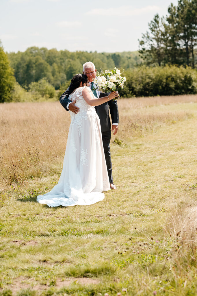 An emotional first look between the bride and her father at Ivy Black, a moment of love and anticipation