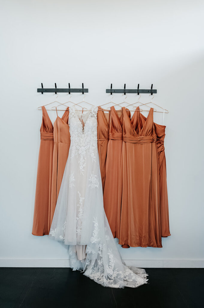 Bride and bridesmaid dresses on hangers 