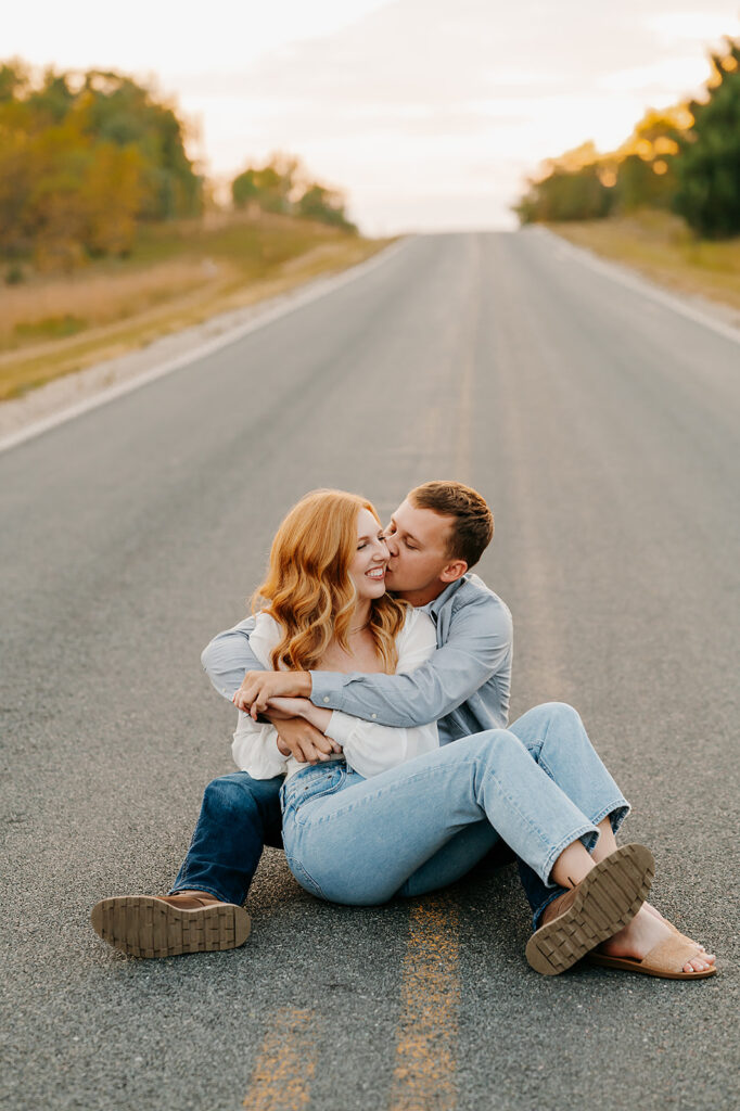 engaged couple on an empty road for their engagement photos