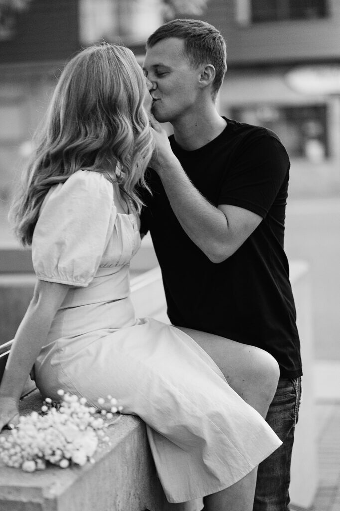 bride and groom sharing playful and intimate moments in downtown Bemidji