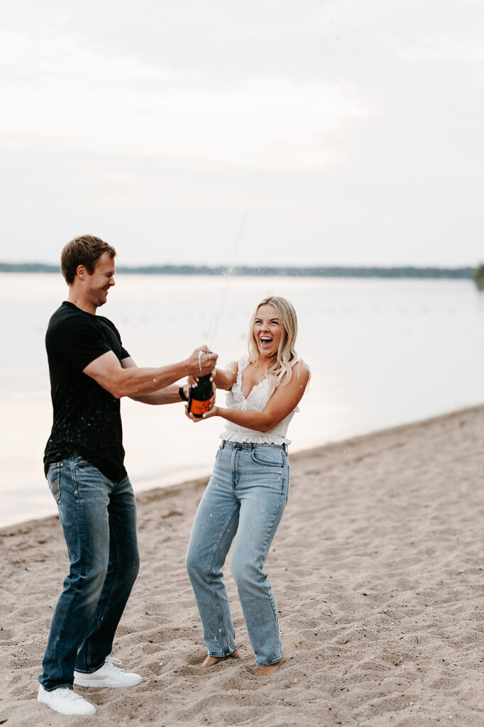 Engaged couple captured in a romantic setting by the water in Bemidji