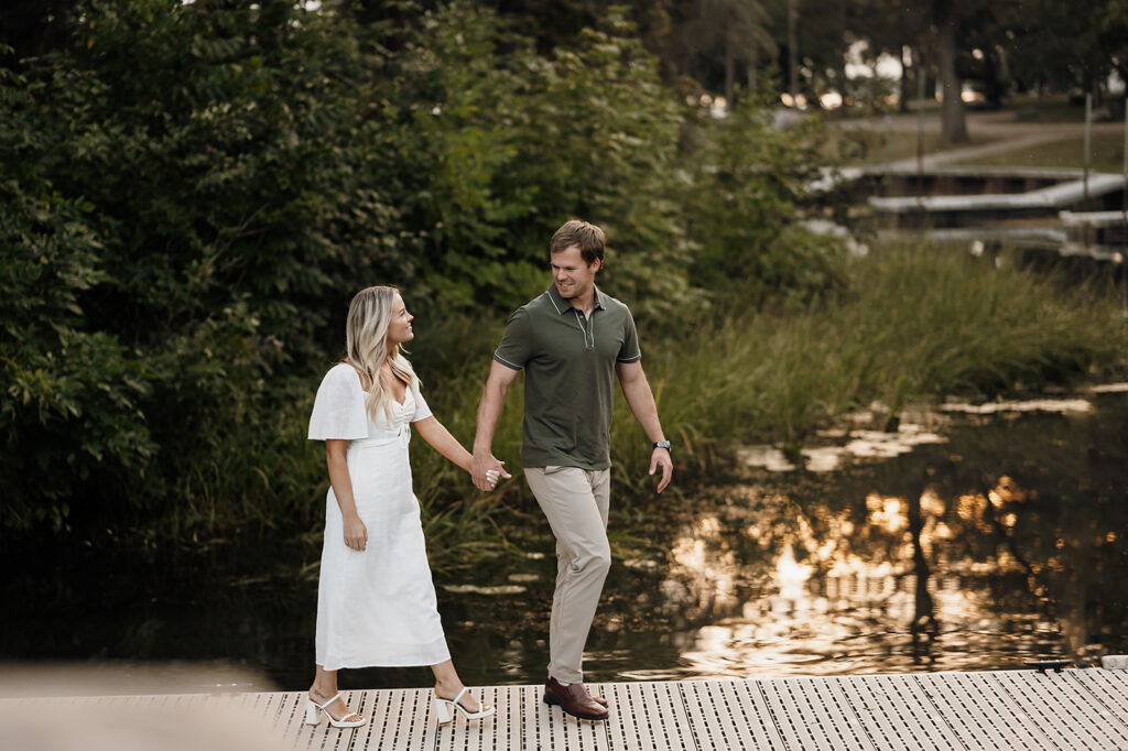 Engaged couple captured in a romantic setting by the water in Bemidji