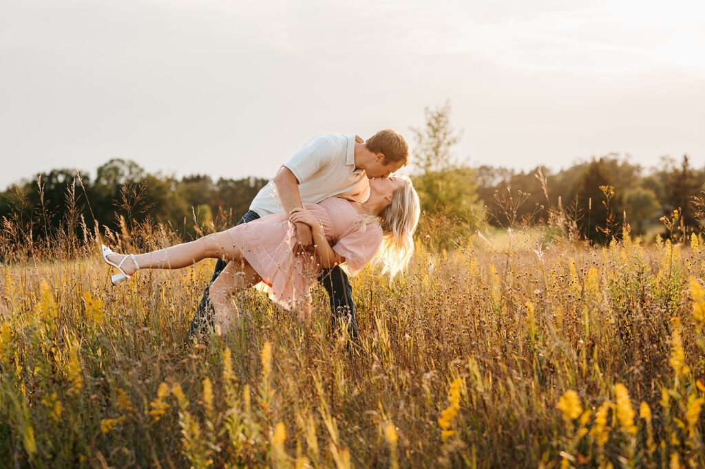Couple walking together amidst tall grasses for field engagement photos in Bemidji, MN
