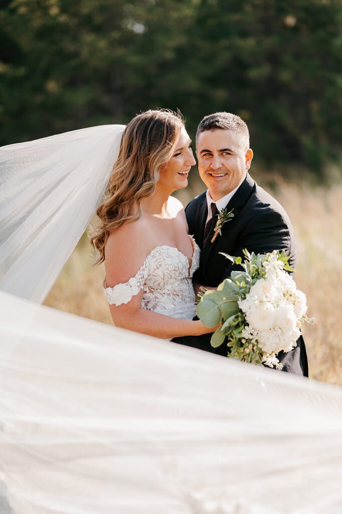 Romantic golden hour photos of the bride and groom at the Bemidji wedding venue, with warm sunlight casting a soft glow on the couple as they embrace, surrounded by a picturesque natural setting