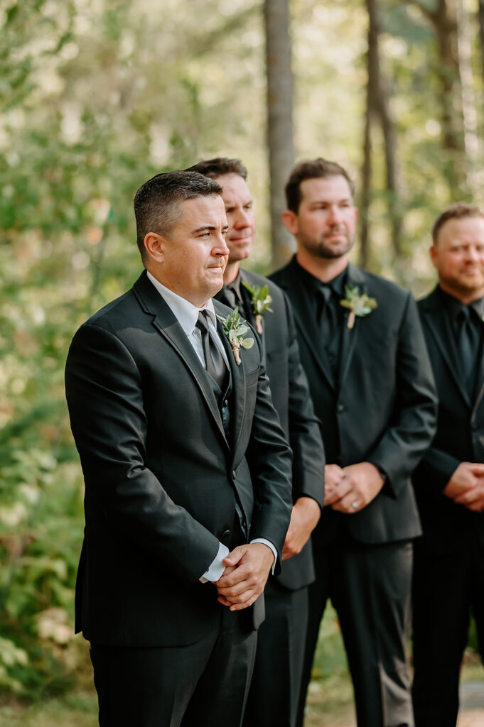 Emotional groom photo as he awaits his bride walking down the aisle with her father