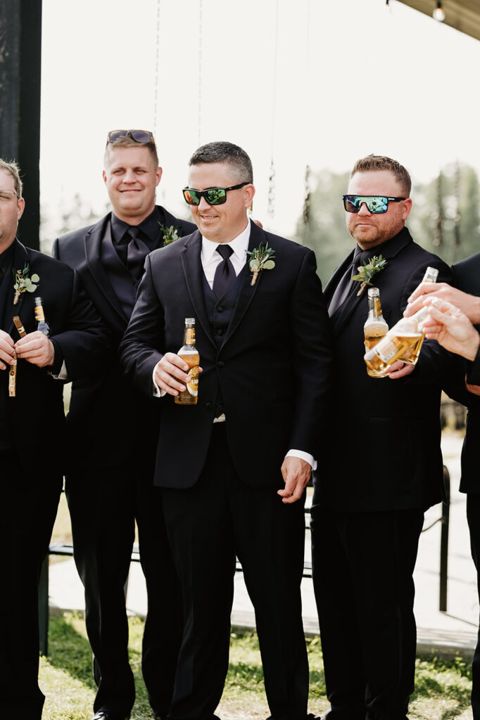 Lighthearted and fun photos of the groom and his groomsmen at the Bemidji wedding venue, all dressed sharply in suits, sharing laughs and candid moments