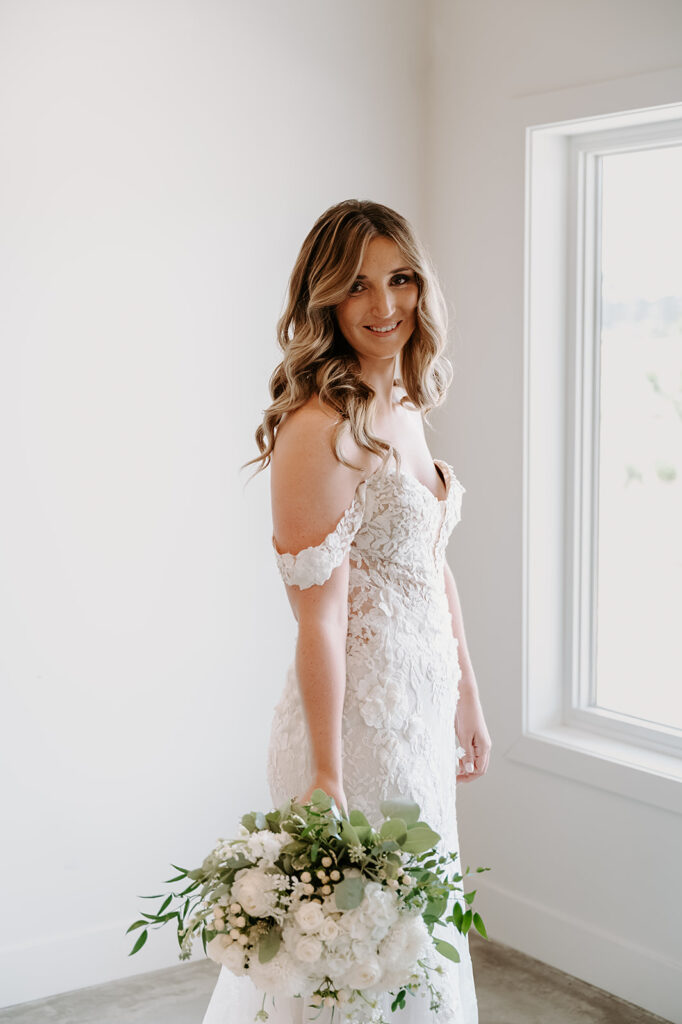 Elegant indoor bridal portraits at the Bluebelle Event Venue, featuring the bride in her exquisite wedding dress, posing gracefully with sophisticated decor and soft lighting enhancing her radiant beauty