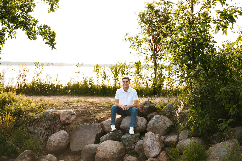A senior photo capturing a boy student by the water