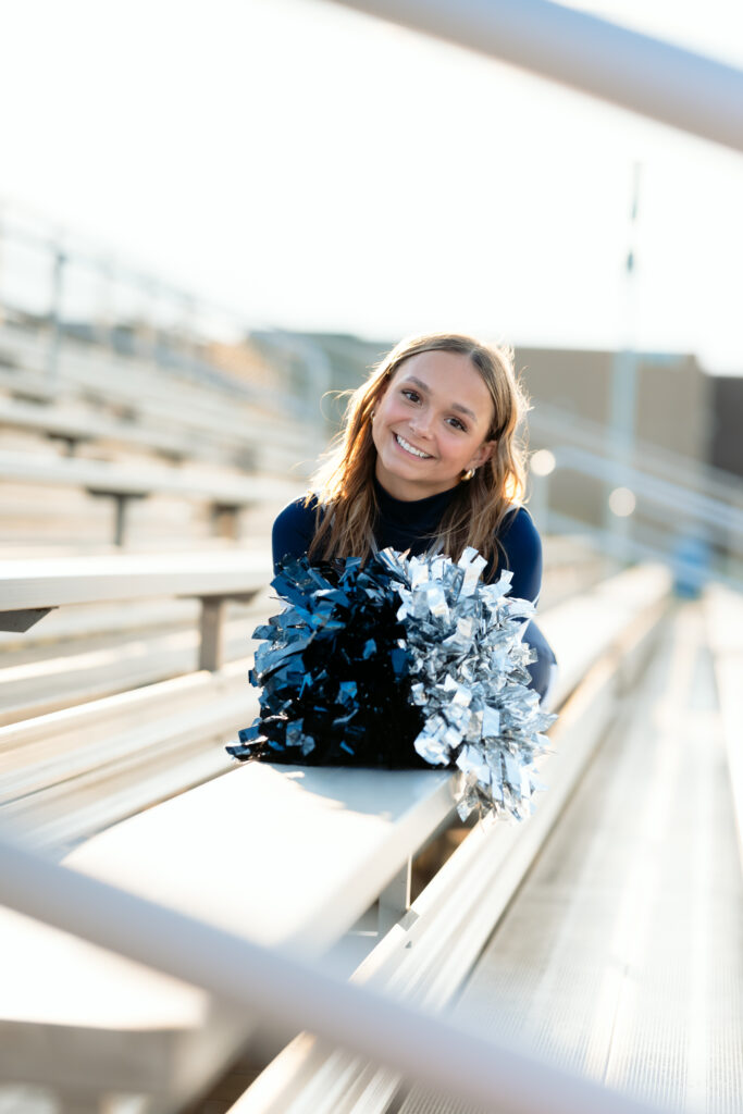 high school senior in a cheerleader uniform for her senior photos in minnesota