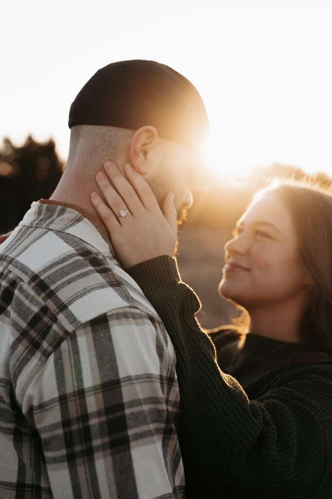 romantic and playful winter golden hour engagement photos in a gorgeous field in Minnesota