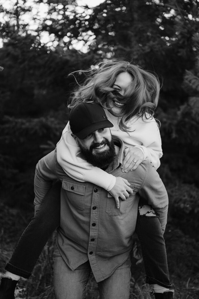 Super fun engagement photos of Cole giving Alexis a piggy back ride, both of them laughing