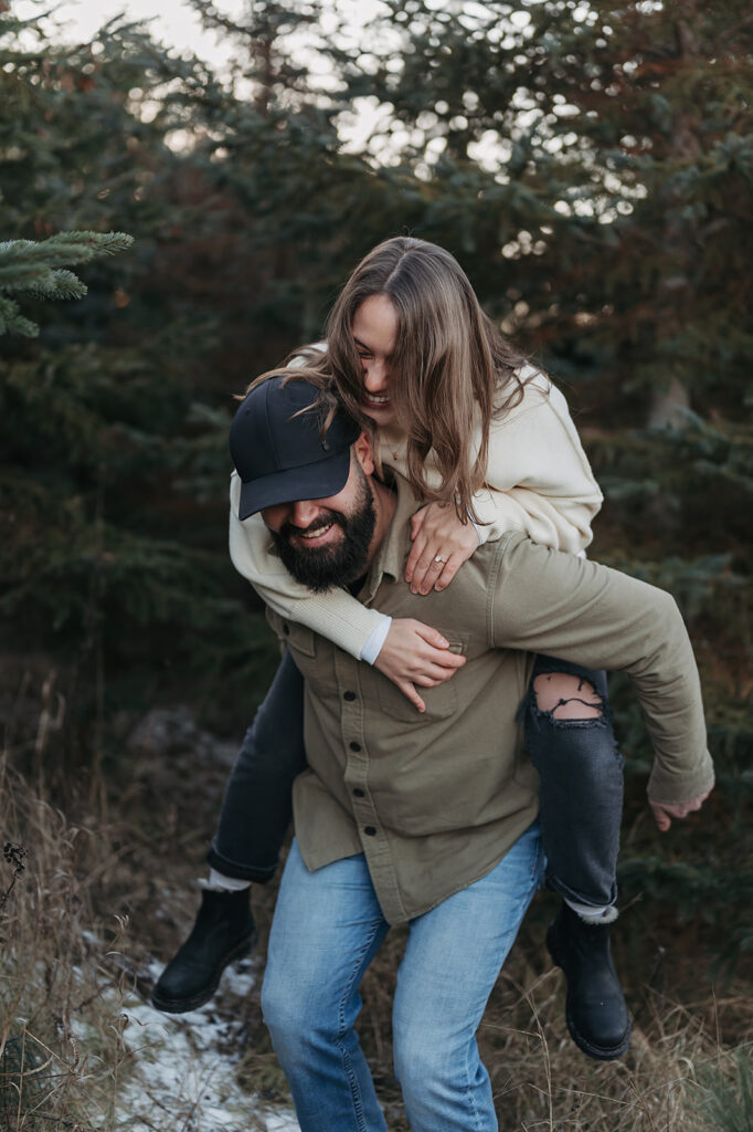 Super fun engagement photos of Cole giving Alexis a piggy back ride, both of them laughing