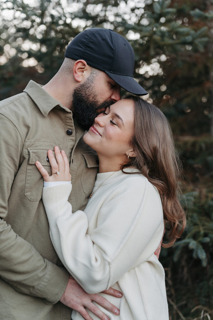 romantic engagement photos in Minnesota, couple wearing casual engagement outfits with jeans and sweaters