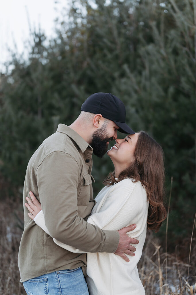 romantic and playful winter engagement session in a field in Bemidji, MN
