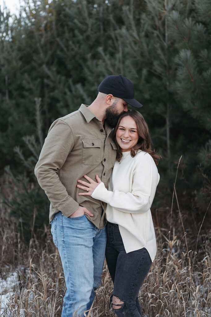romantic and playful winter engagement session in a field in Bemidji, MN