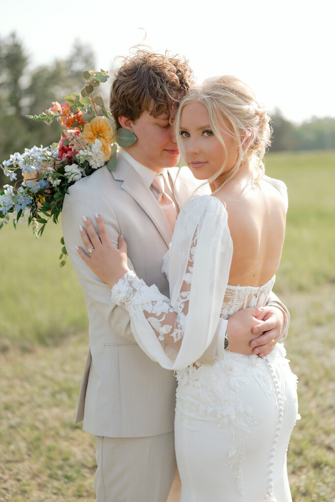 bride and groom in a lush field during their wedding at bluebelle event venue in bemidji mn