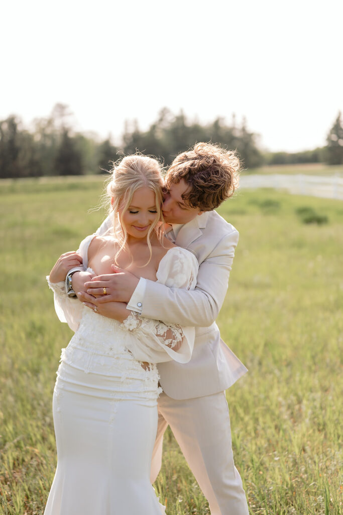 bride and groom in a lush field during their wedding at bluebelle event venue in bemidji mn