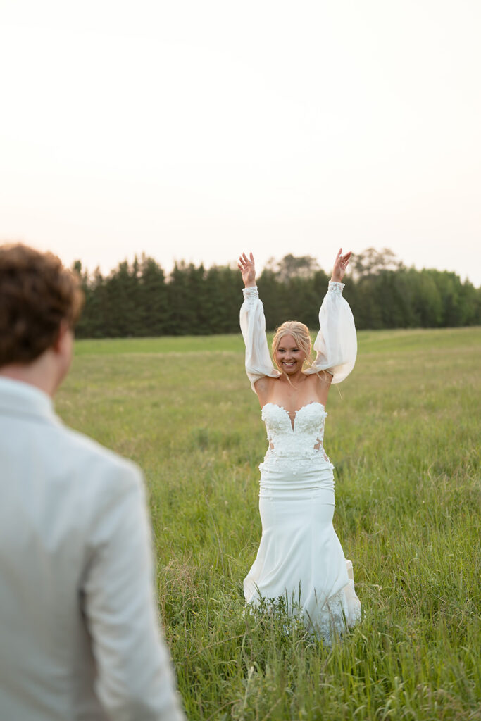 bride and groom in a lush field during their wedding at bluebelle event venue in bemidji mn