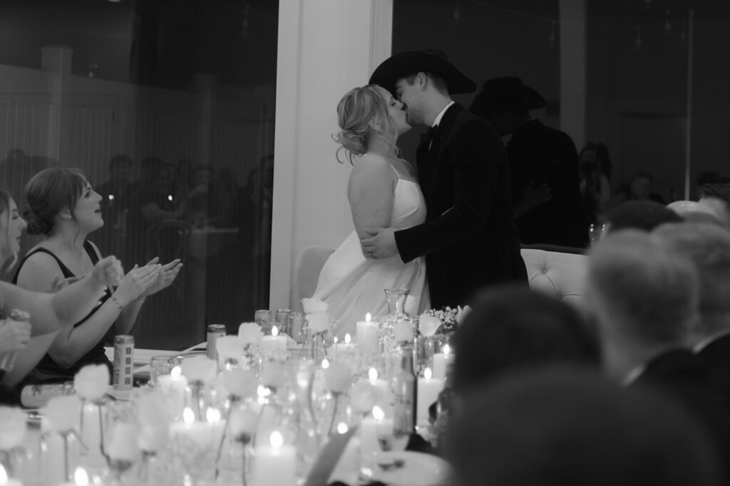Elegant table setup with candles and white roses at The Aisling wedding reception