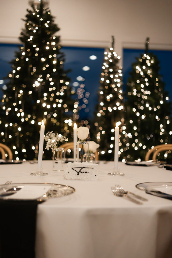 Elegant table setup with candles and white roses at The Aisling wedding reception