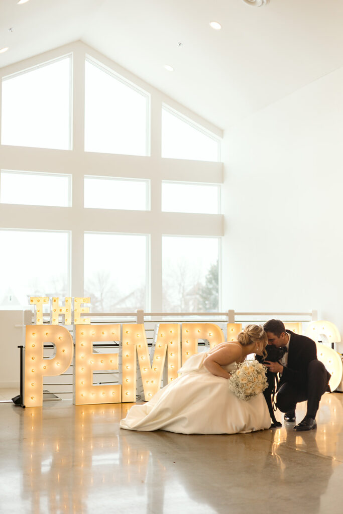 bride and groom snuggling their dog