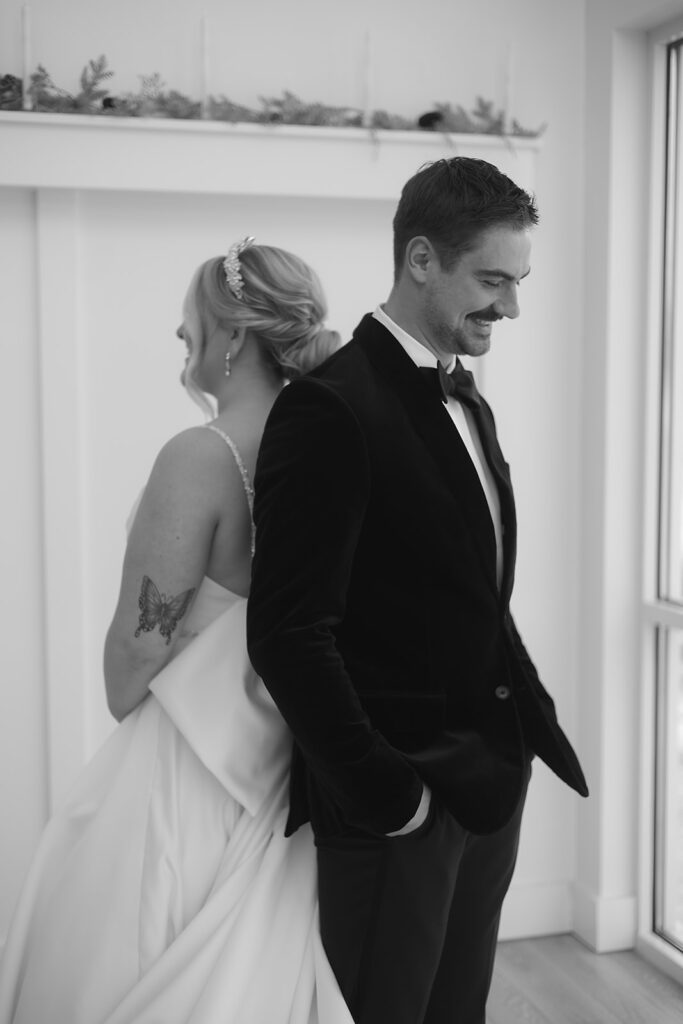 Bride and groom standing back-to-back for private vow reading at The Aisling wedding venue