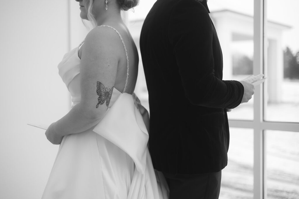 Bride and groom standing back-to-back for private vow reading at The Aisling wedding venue