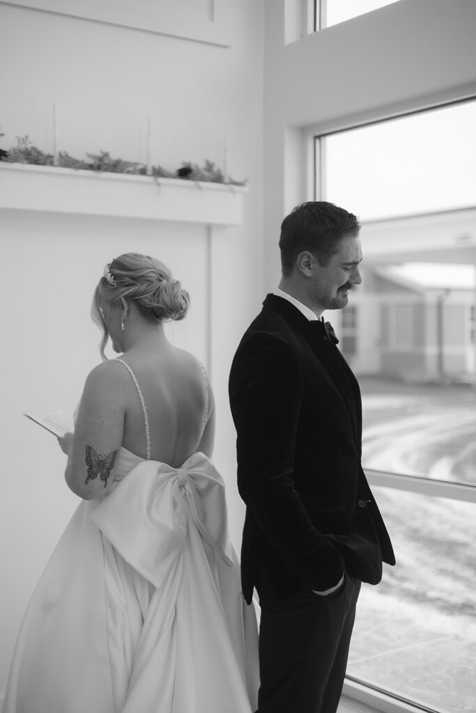 Bride and groom standing back-to-back for private vow reading at The Aisling wedding venue