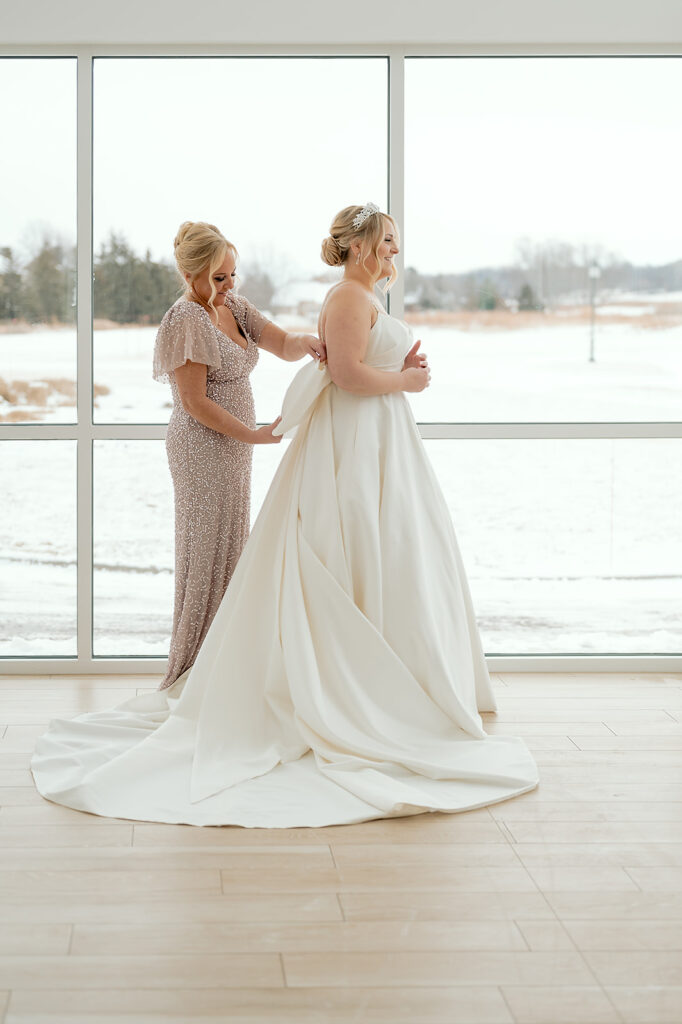 mom helping bride get ready for the big day