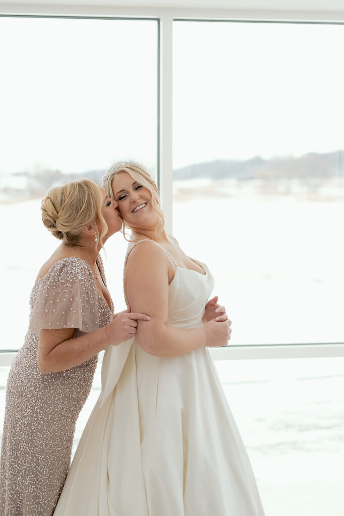 mom helping bride get ready for the big day