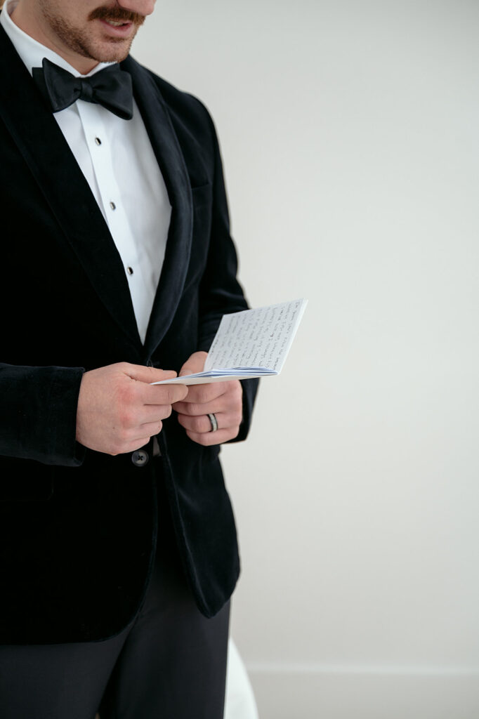 Bride and groom standing back-to-back for private vow reading at The Aisling wedding venue