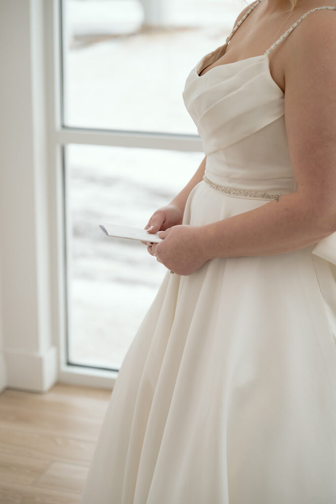 Bride and groom standing back-to-back for private vow reading at The Aisling wedding venue