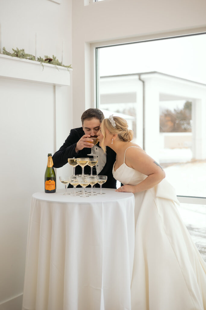 Bride and groom enjoying a champagne tower together