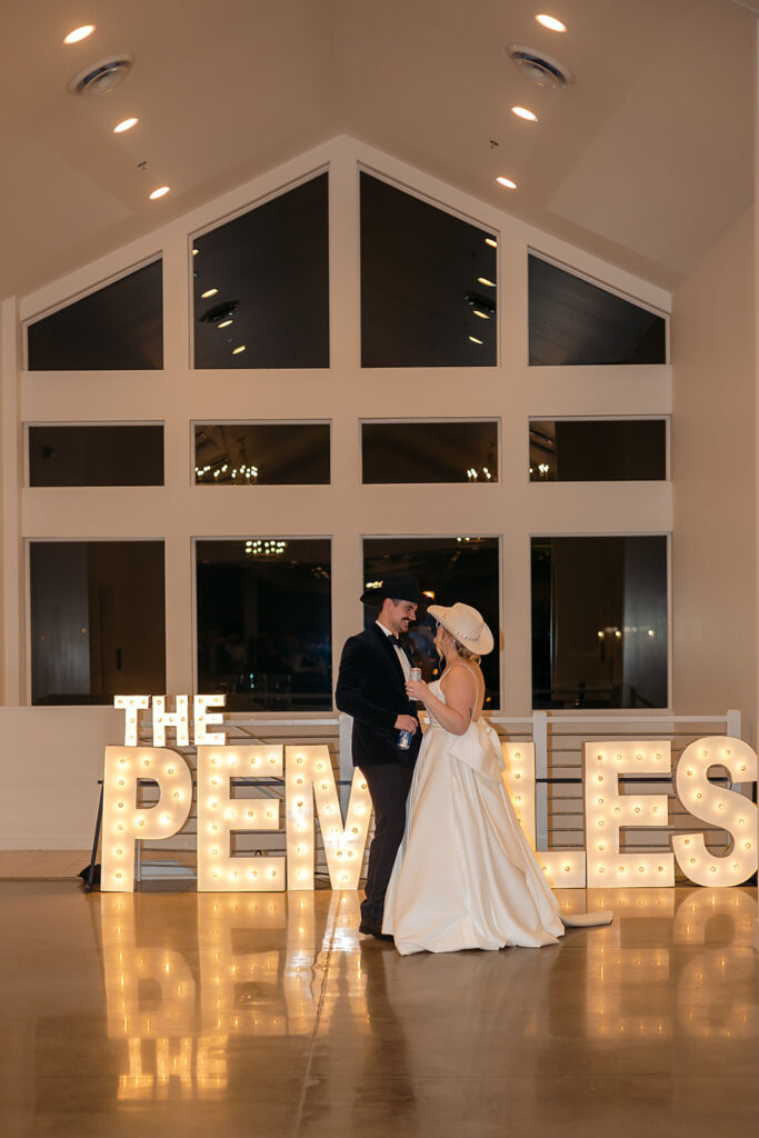 Bright marquee letters spelling “The Pemble’s” during wedding reception at The Aisling