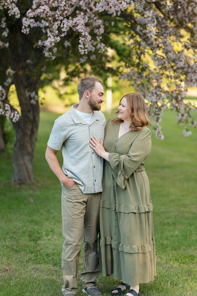 romantic spring engagement photos with blooming crab trees in the background