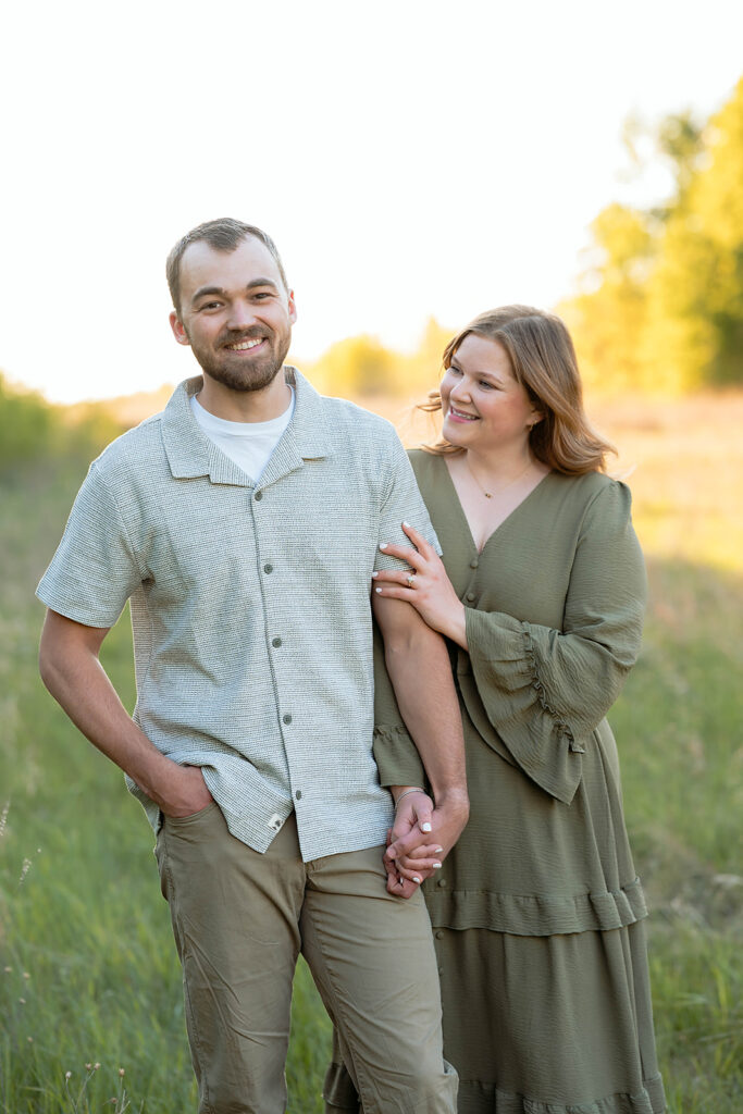 sweet couple in a field during their spring engagement session in Minnesota