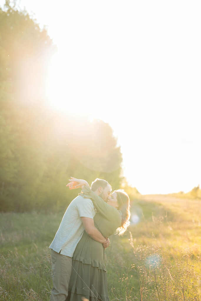 playful couple in a field during golden hour in Minnesota