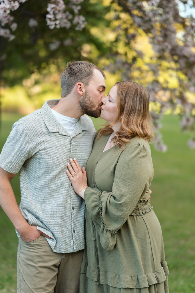 romantic spring engagement photos with blooming crab trees in the background