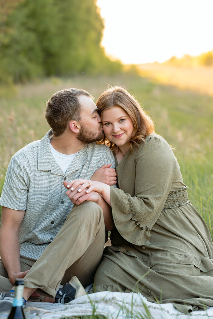 sweet couple in a field during their spring engagement session in Minnesota