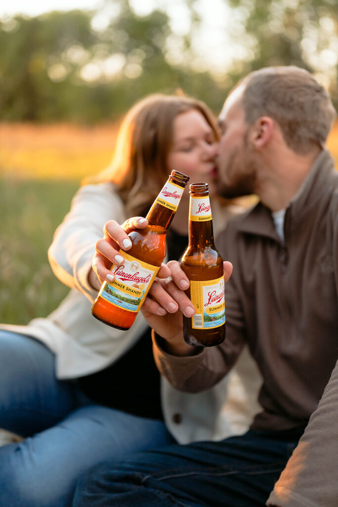couple having a picnic in a field for their minnesota spring engagement