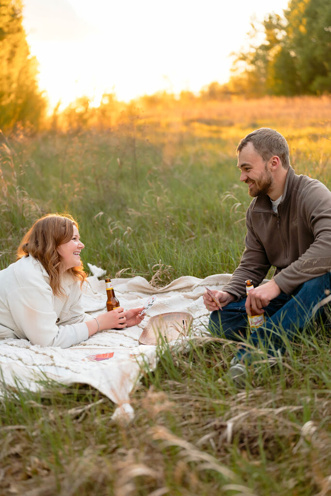 couple having a picnic and playing cribbage in a field in Minnesota