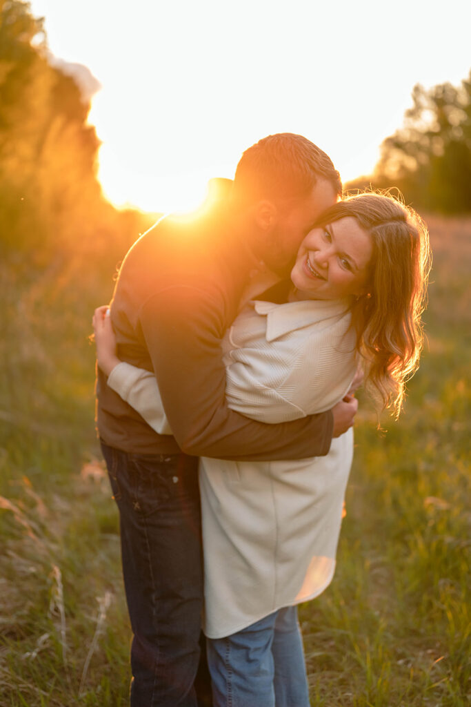 couple in a lush field during golden hour in minnesota