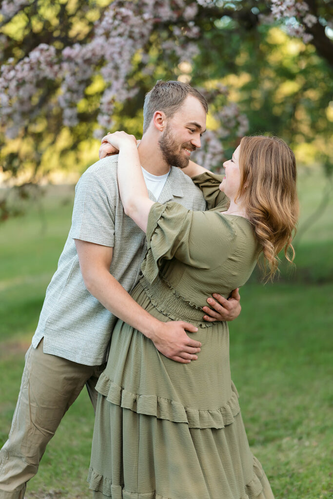 romantic spring engagement photos with blooming crab trees in the background