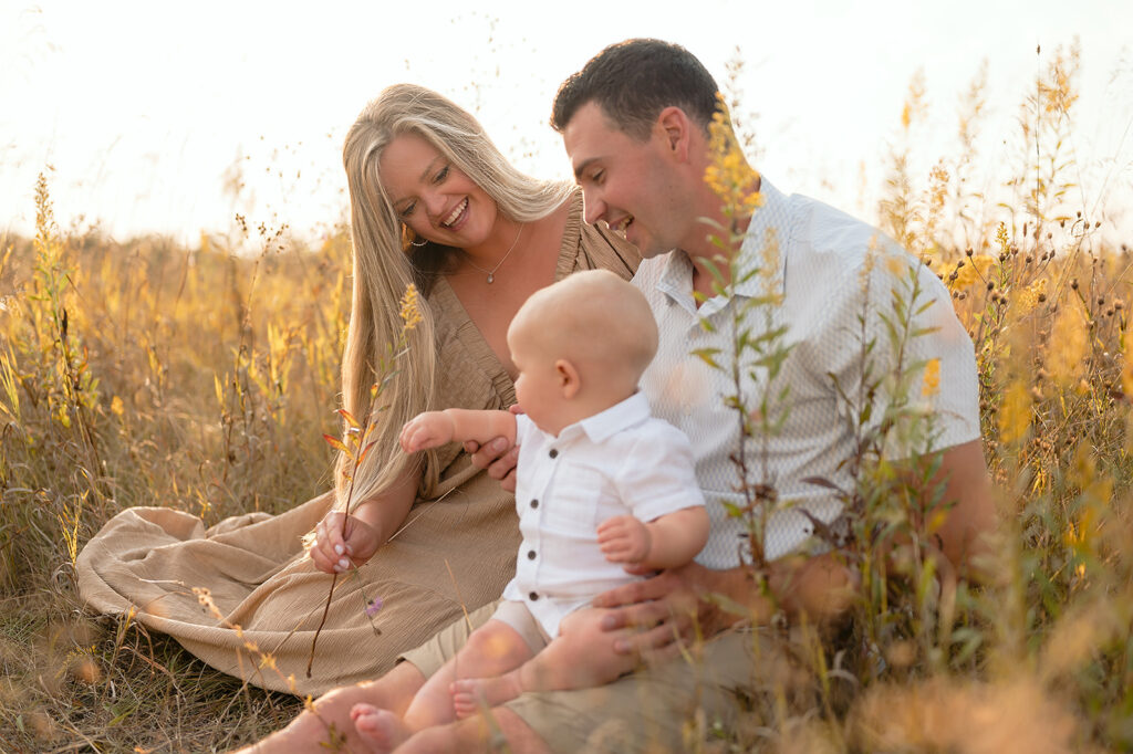 mom, dad and their two little sons in a  lush golden field in Minnesota